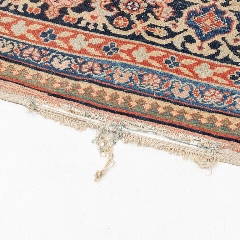 An oriental, semi-antique carpet, c. 415 x 365 cm.