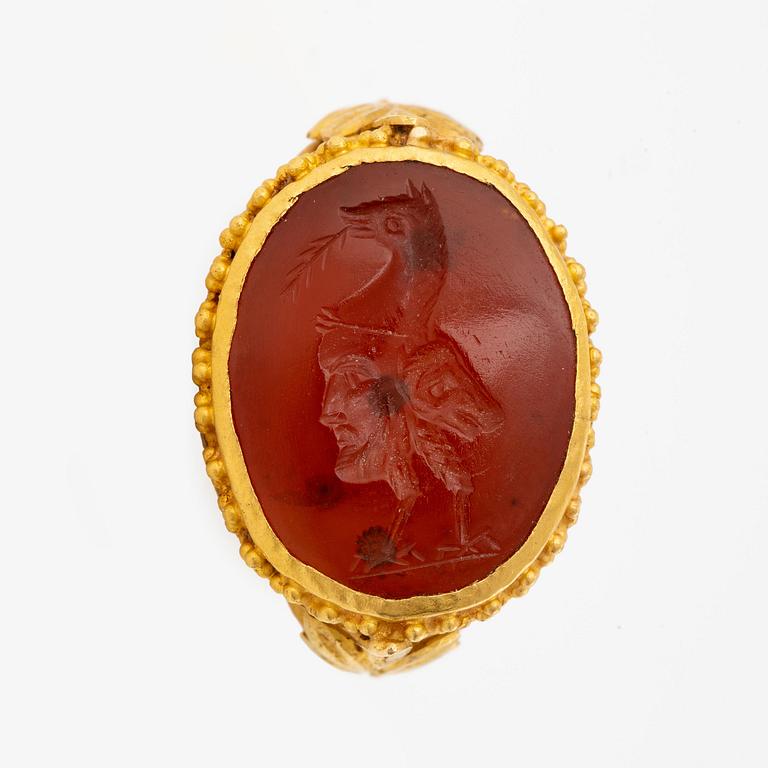 A possibly Etruscan gold and carnelian signet ring.