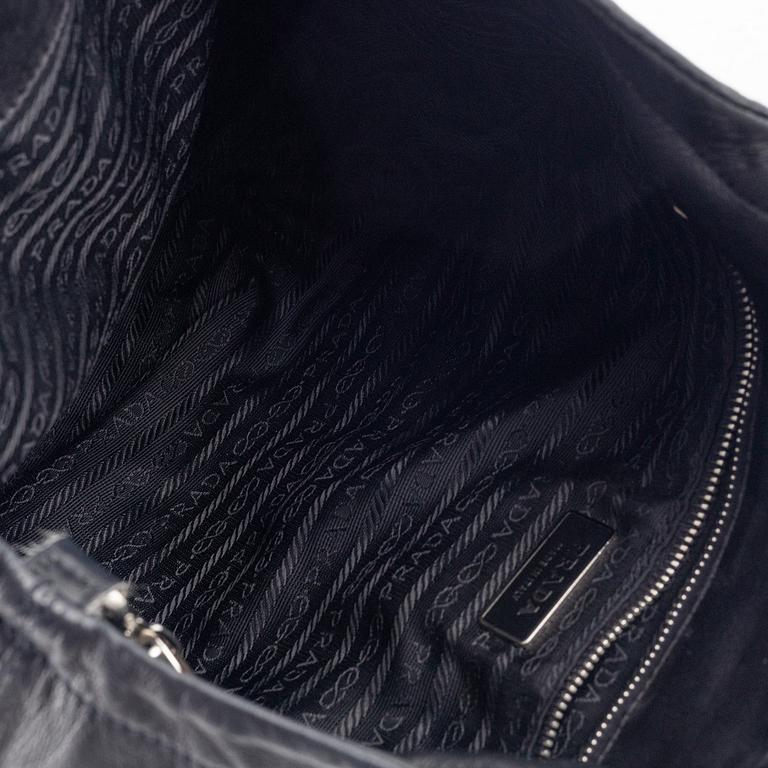 Prada, A black leather bag.