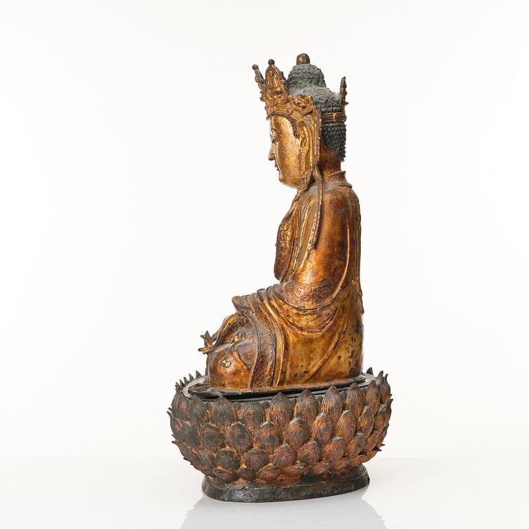 A large cold gilt sculpture of a crowned medicine Buddha/Bhaisjyaguru, Ming dynasty (1368-1644).