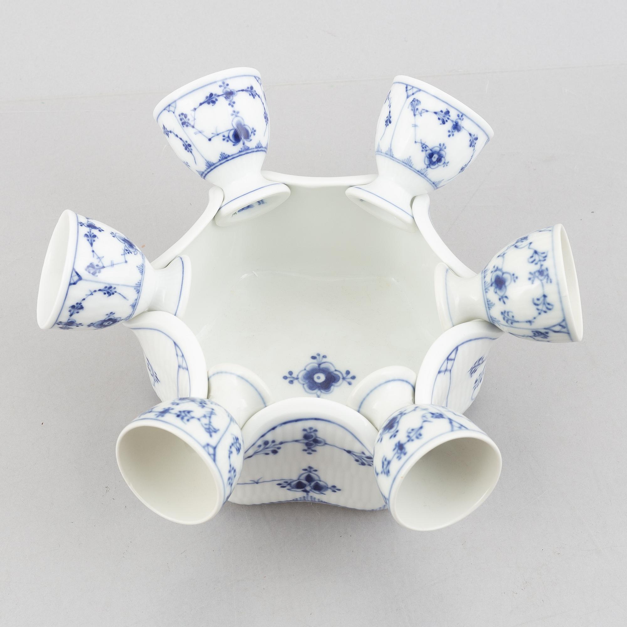 A set with six egg servers, a stand and a salt shaker, "Blue fluted"/"Musselmalet", Royal Copenhagen, part 19th century.