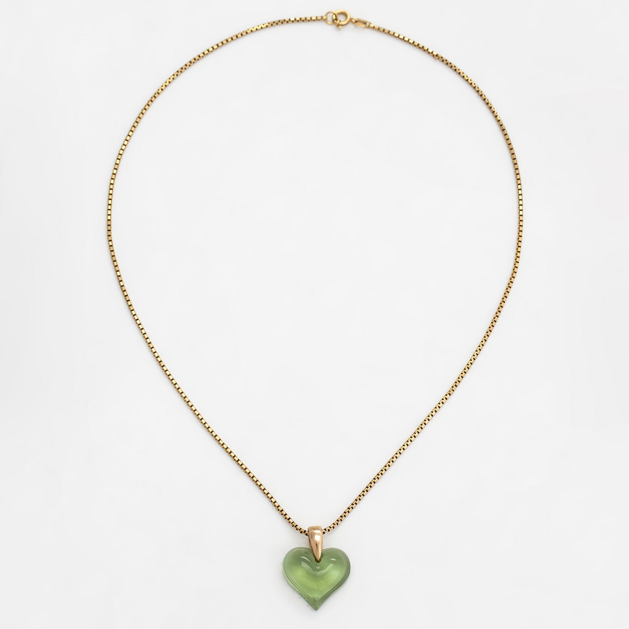 A Lalique heart pendant with an 18K gold chain.