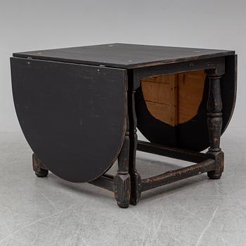 A painted pine Baroque style gate leg table, 20th Century with older parts.