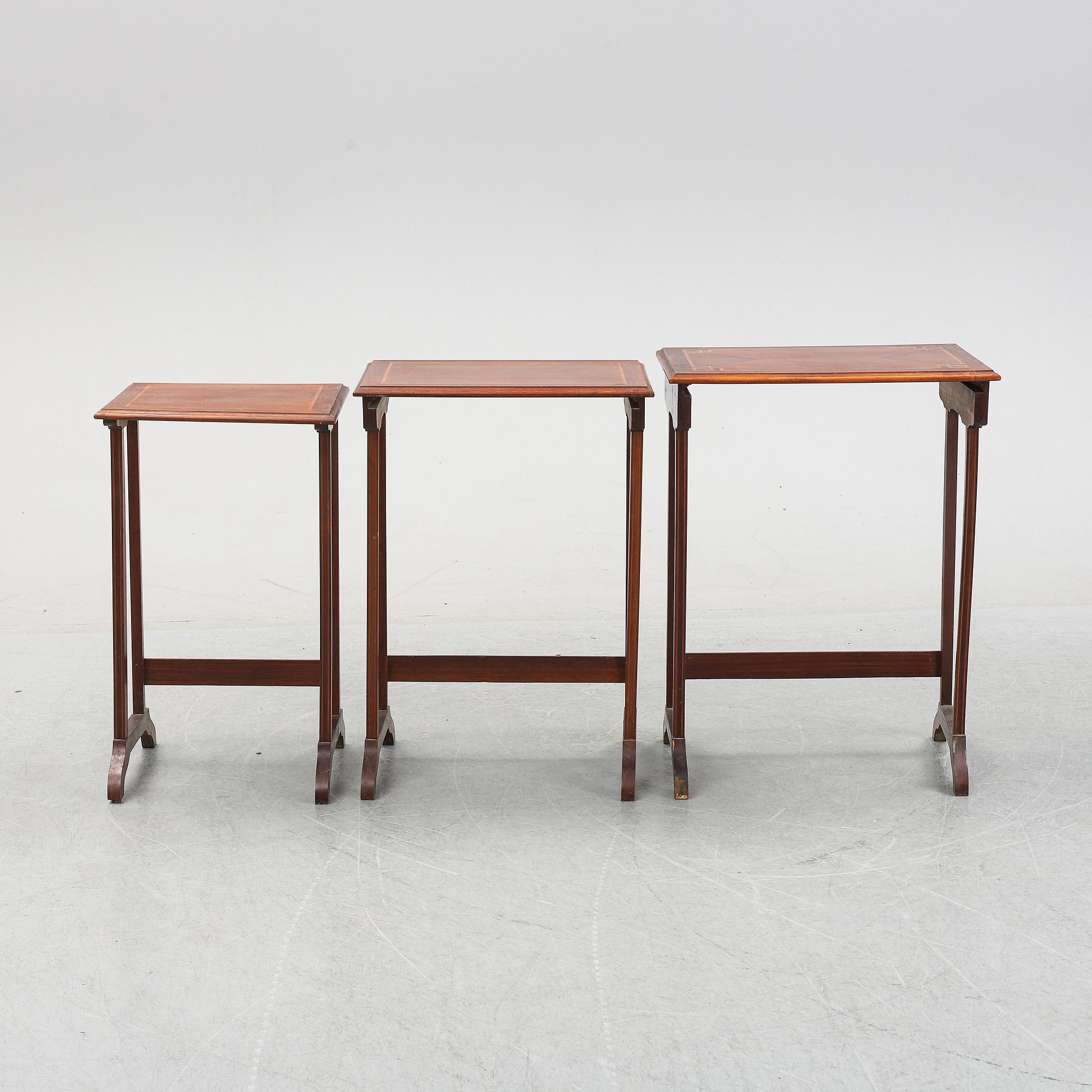 A three piece nesting table with inlay, first half of the 20th Century.