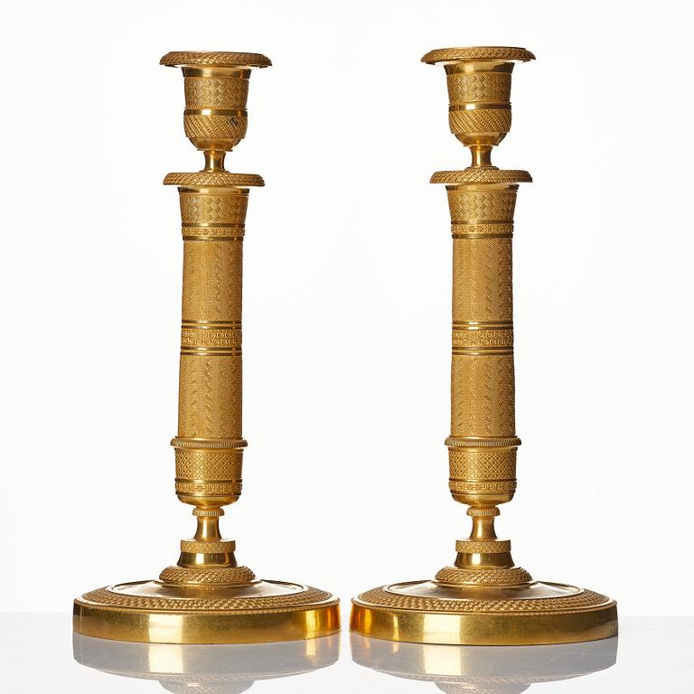 A pair of French gilded Empire candlesticks.