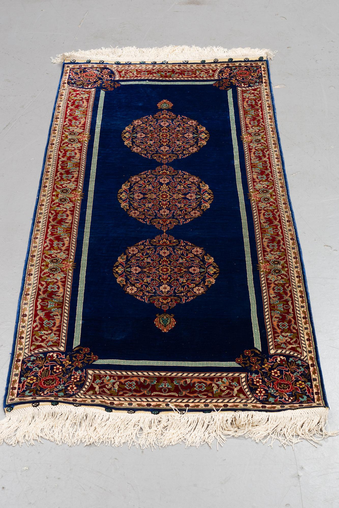 A rug, silk Hereke, ca 143 x 63,5 cm.