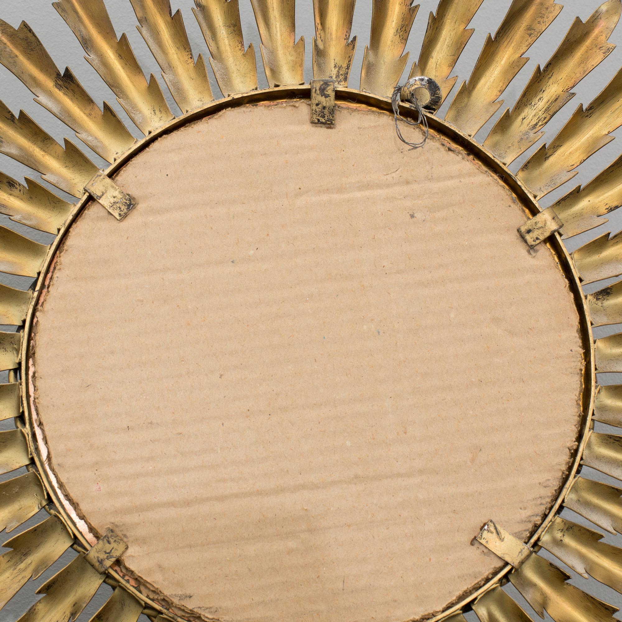 A 20th century metal sun mirror.