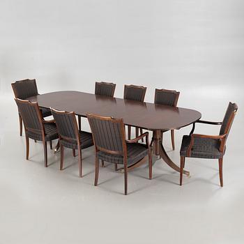 An english style dining table and eight chairs, second half of the 20th century.