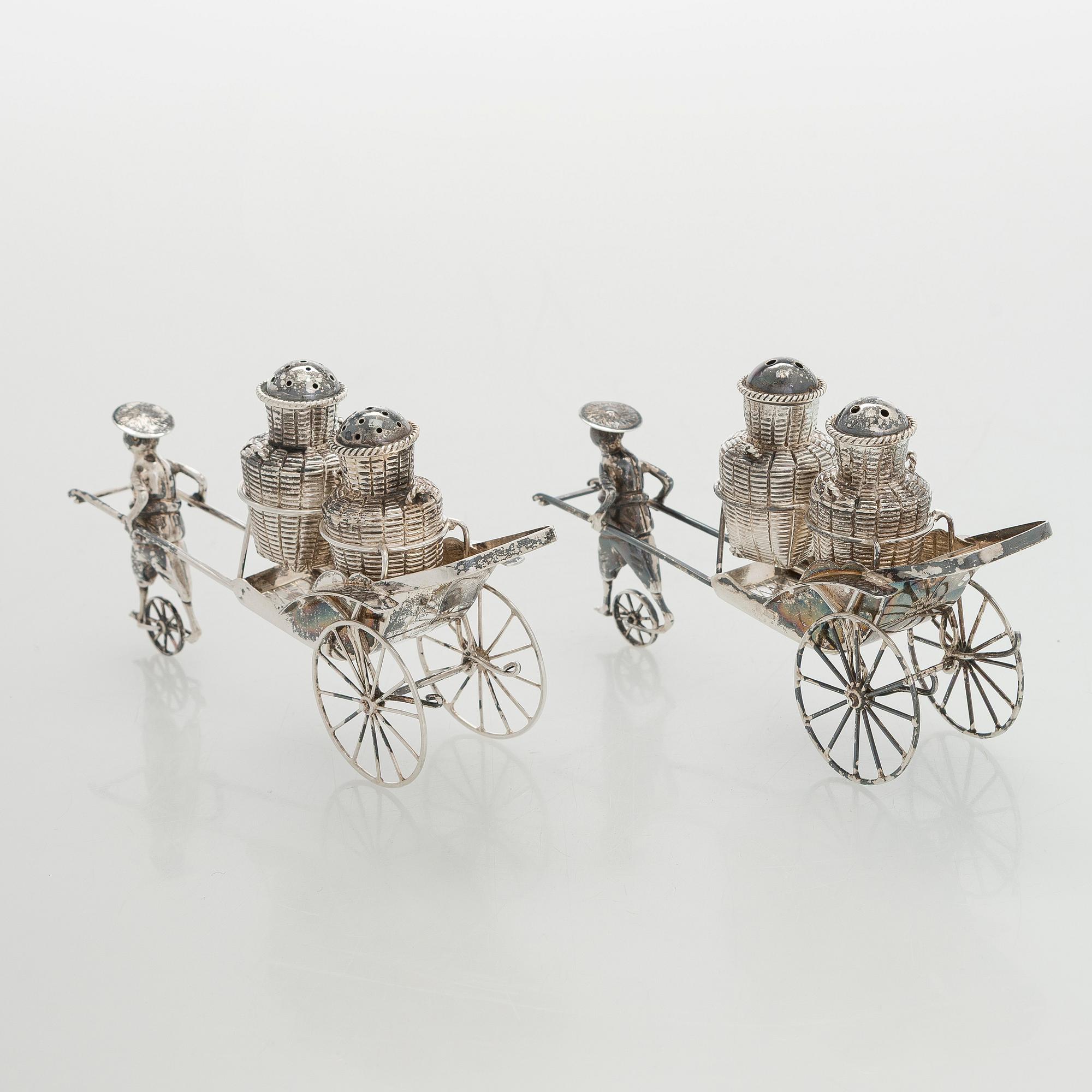 Four shakers in a pair of miniature rickshaws, sterling silver, maker's mark of Wai Kee, Hong Kong.