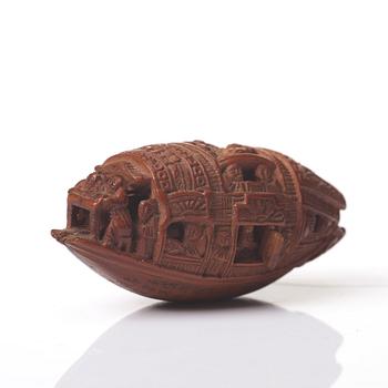 A Chinese nut boat sculpture, with poem.