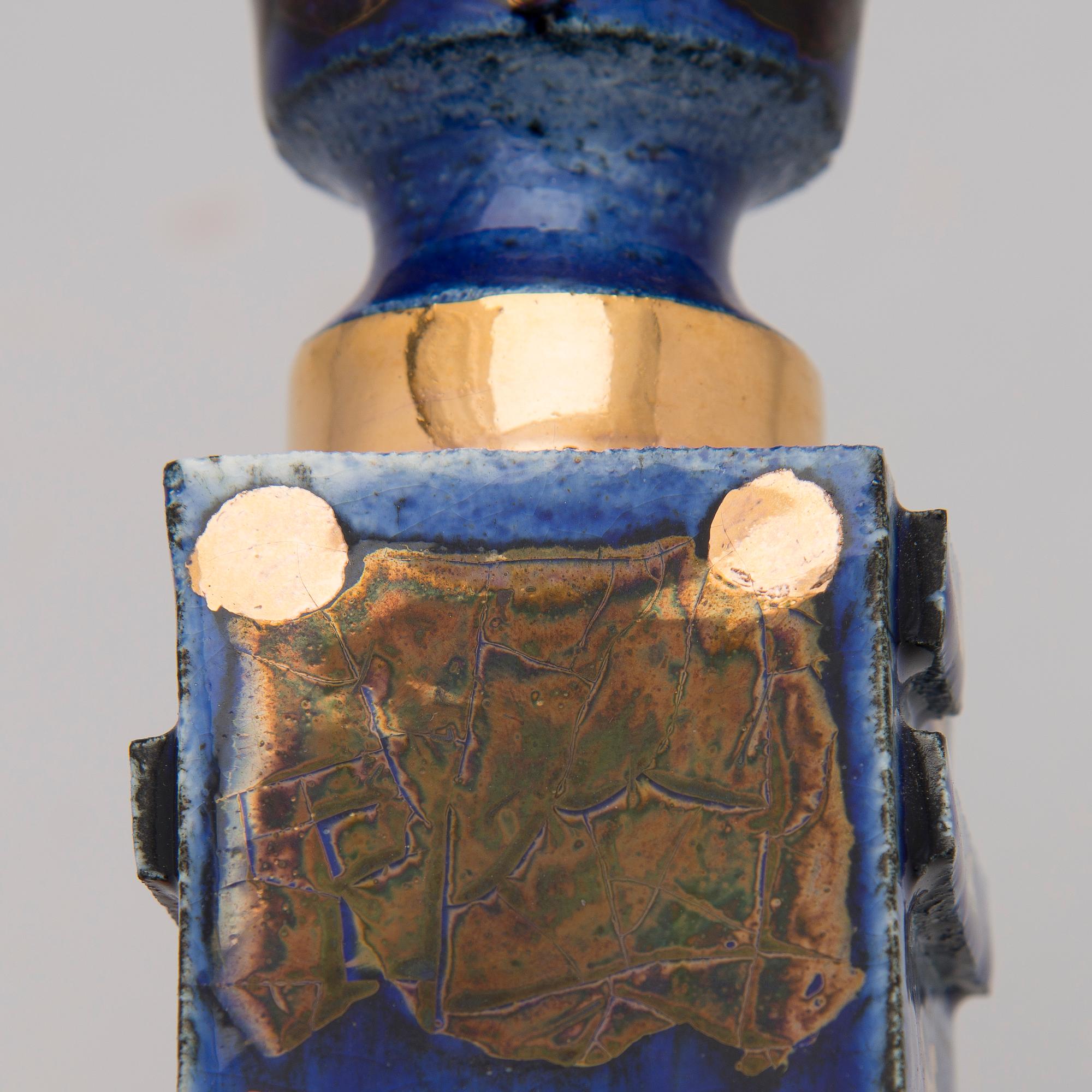 A pair of ceramic candlesticks signed Kaipiainen.