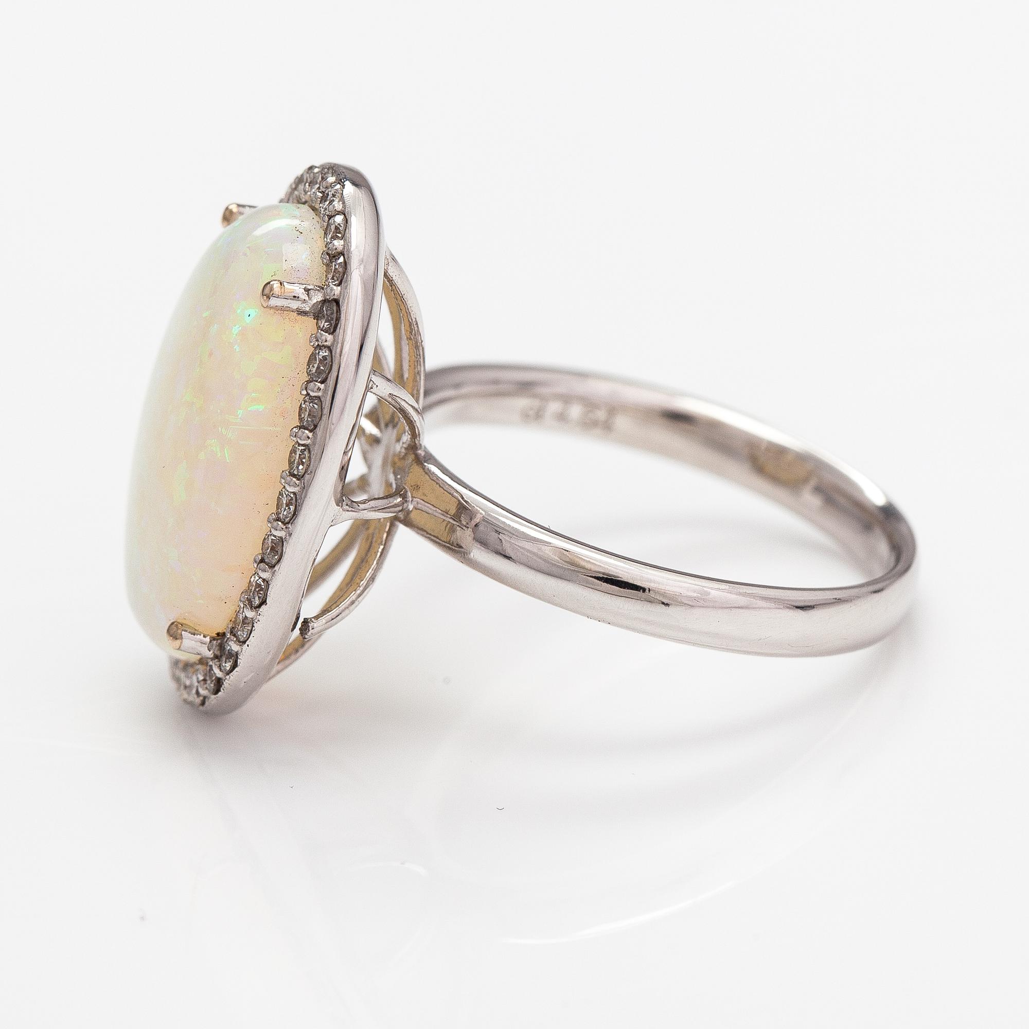 An 18K white gold ring with an opal ca. 4.64 ct and diamonds ca. 0.35 ct in total according to certificate.