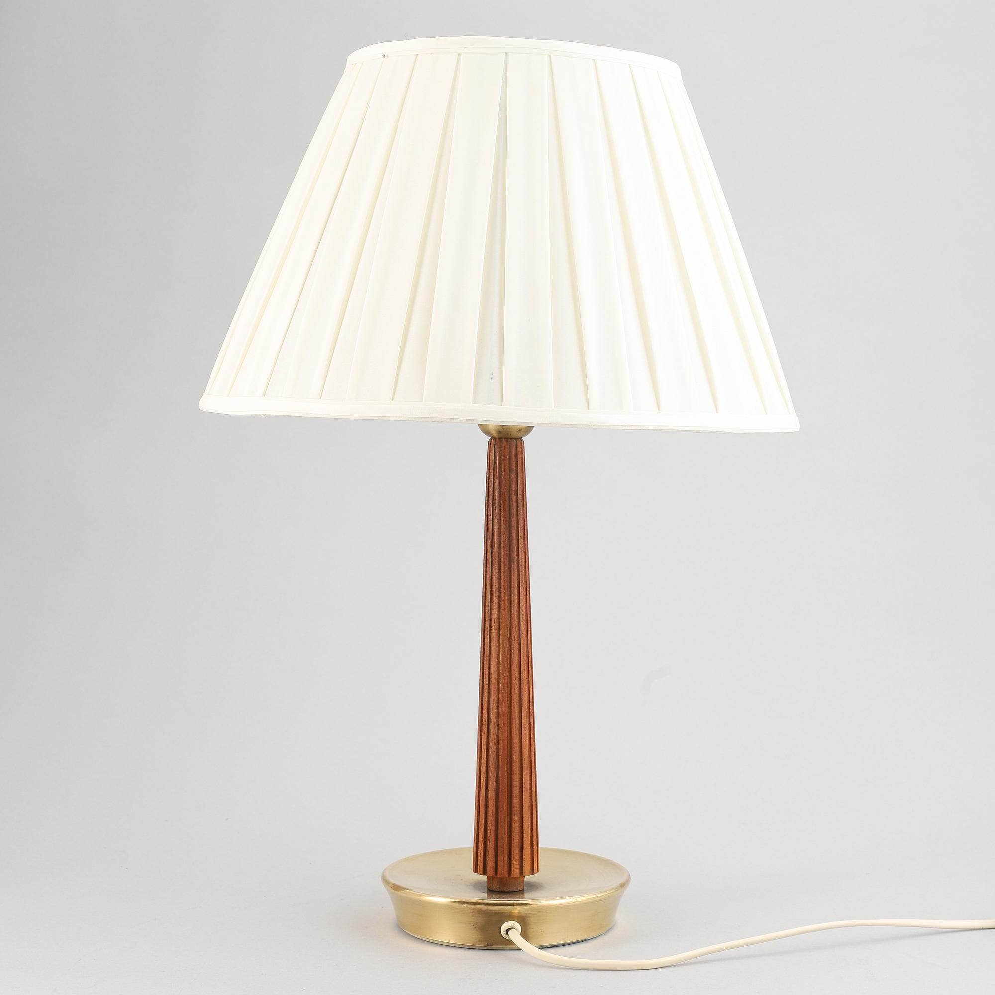 A brass and oak table light by Hans Bergström for ASEA, mid 20th Century.