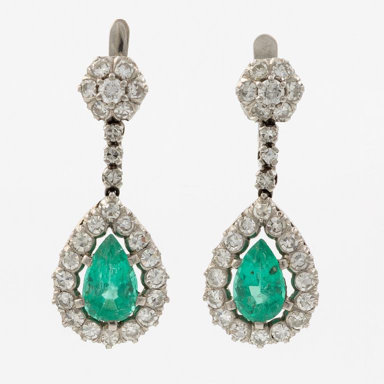 Earrings in platinum with drop-shaped emeralds and brilliant-cut and octagonal-cut diamonds.