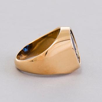 A gold 18K Freemason ring with a synthetic blue sapphire.