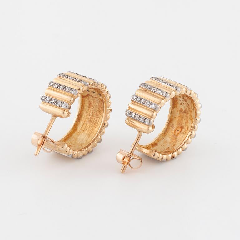 A pair of brilliant cut diamond earrings.