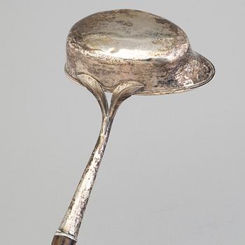 A 19th century silver soup and a sauce ladle with wooden handles.
