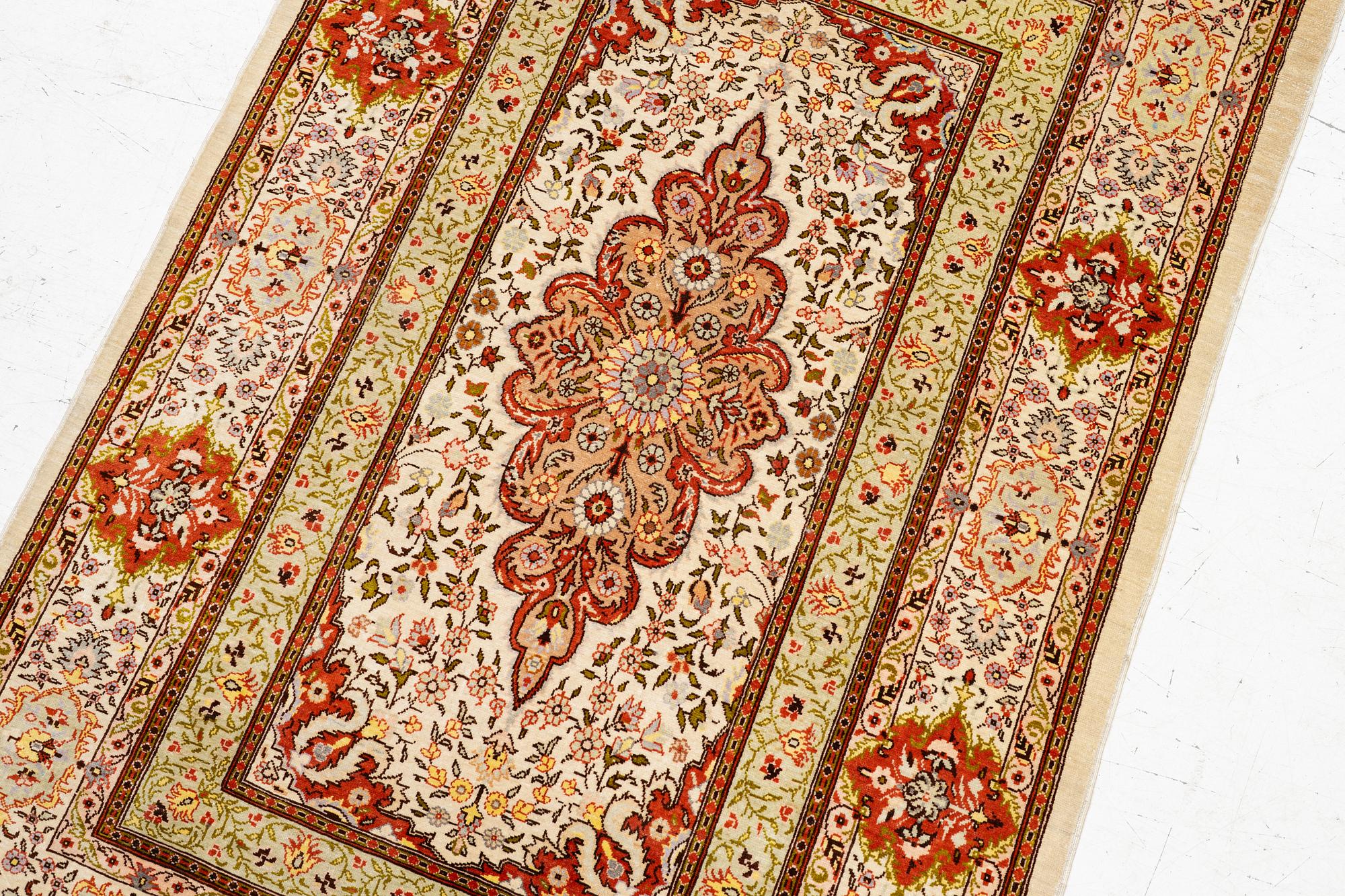 A Hereke silk rug, West Anatolia, c. 107 x 69 cm.