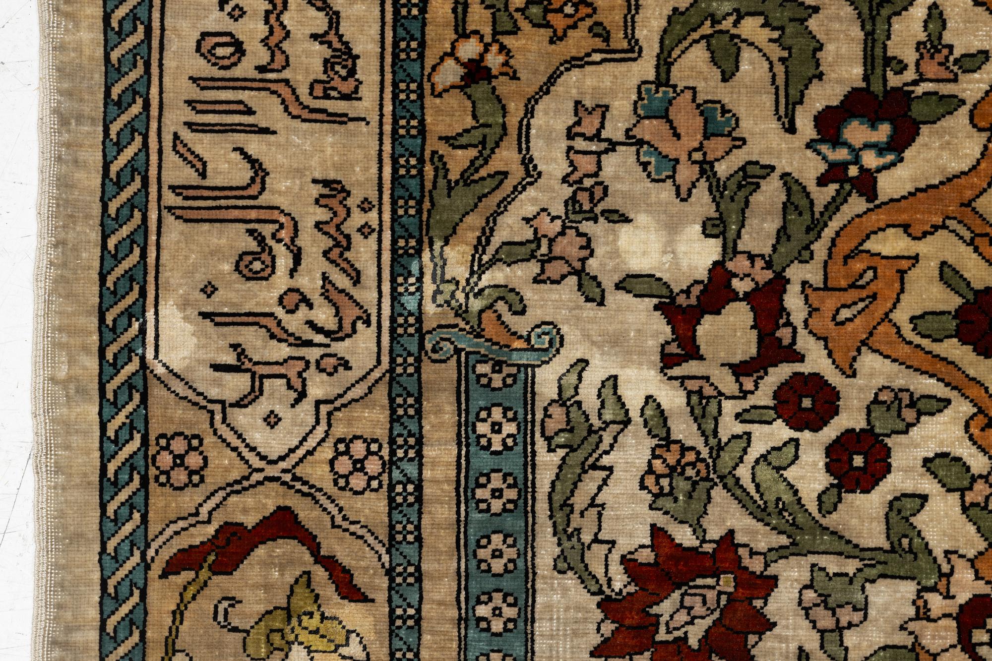 A Hereke silk rug, c. 73 x 52 cm.