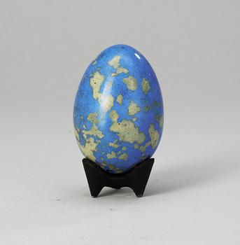 A Hans Hedberg faience egg on an iron base, Biot, France.