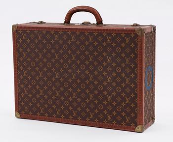 A monogram canvas suitcase by Louis Vuitton.
