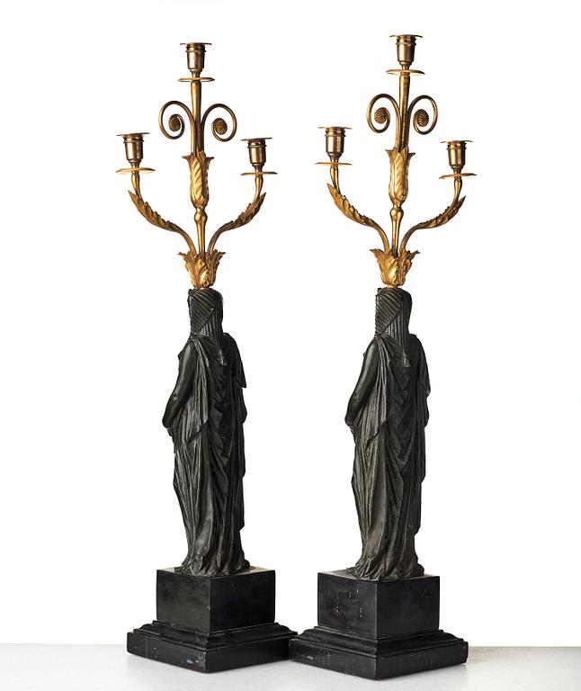 A pair of French Empire early 19th century three-light candelabra.