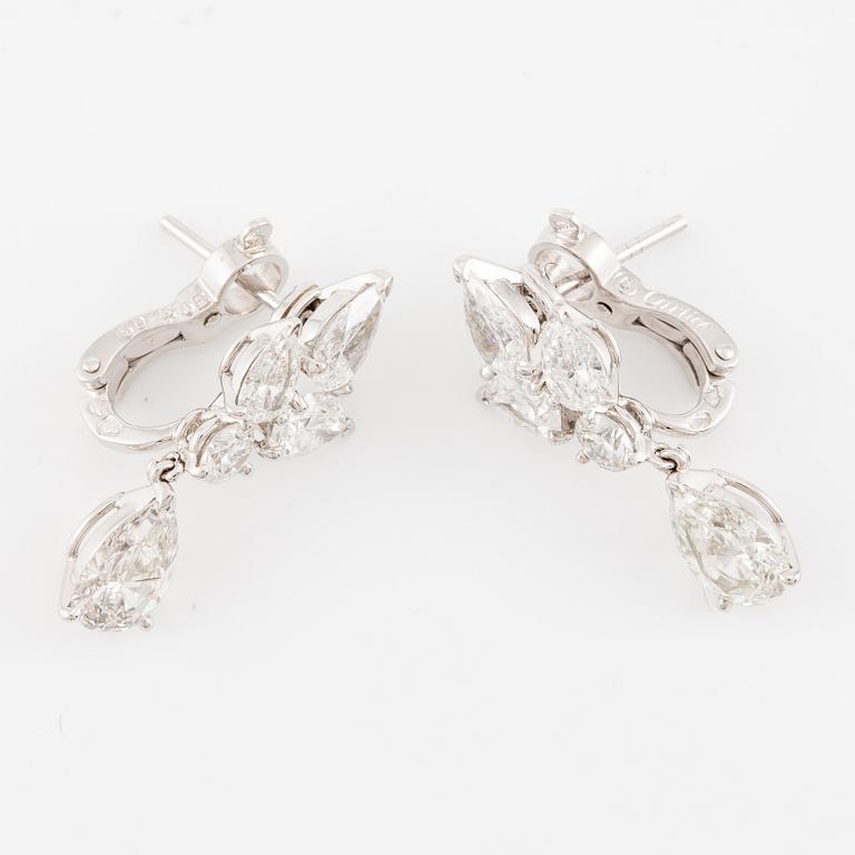 Cartier a pair of earrings platinum set with drop-shaped and round brilliant-cut diamonds.