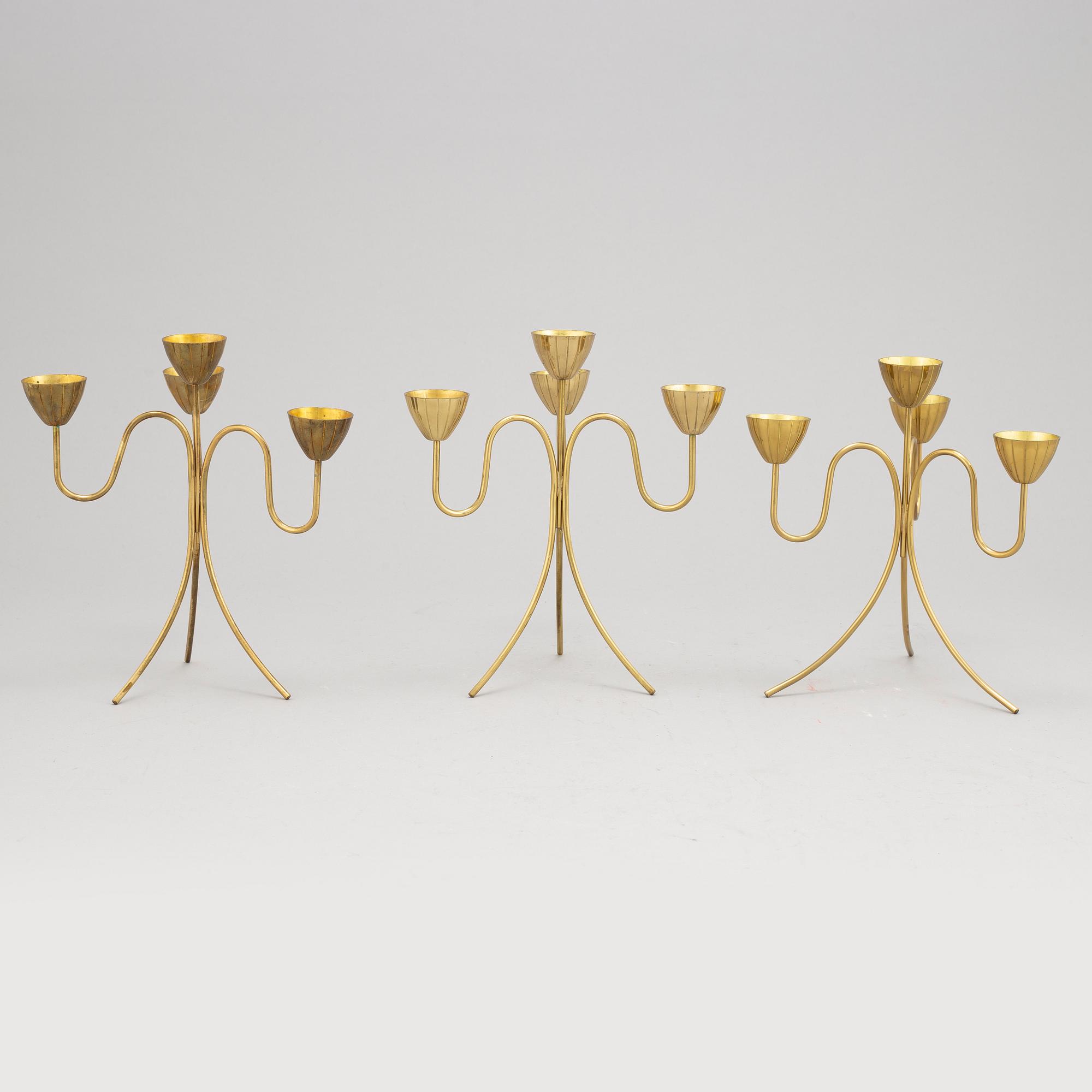 Gunnar Ander, a set of three brass five-light candelabra from Ystad Metall.