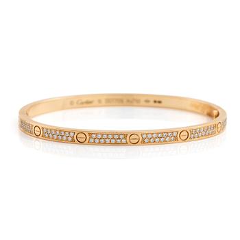 A Cartier "Love" bracelet small model in 18K gold set with round brilliant-cut diamonds. size 16, total weight 17 g. Signed Cartier, numbered DOT70...