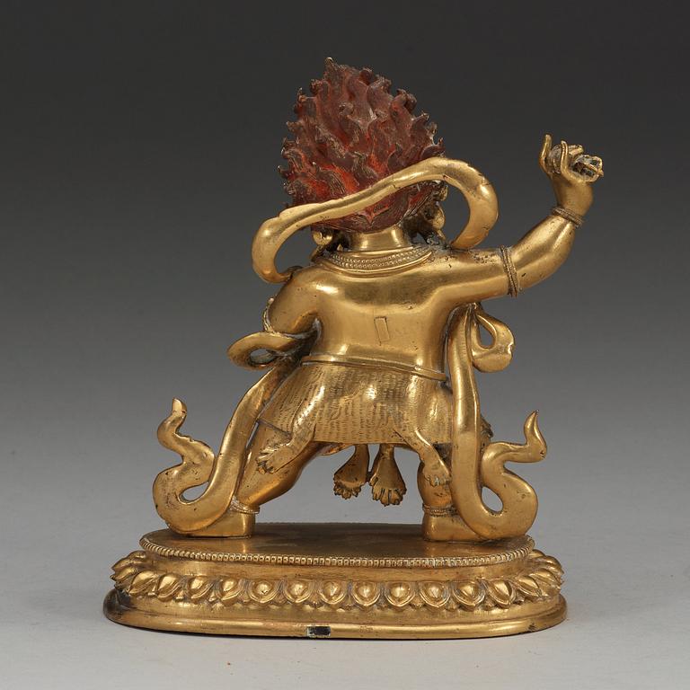 A Sinotibetan gilt bronze figure of a Dharmapala, Qing dynasty, presumably 18th Century.