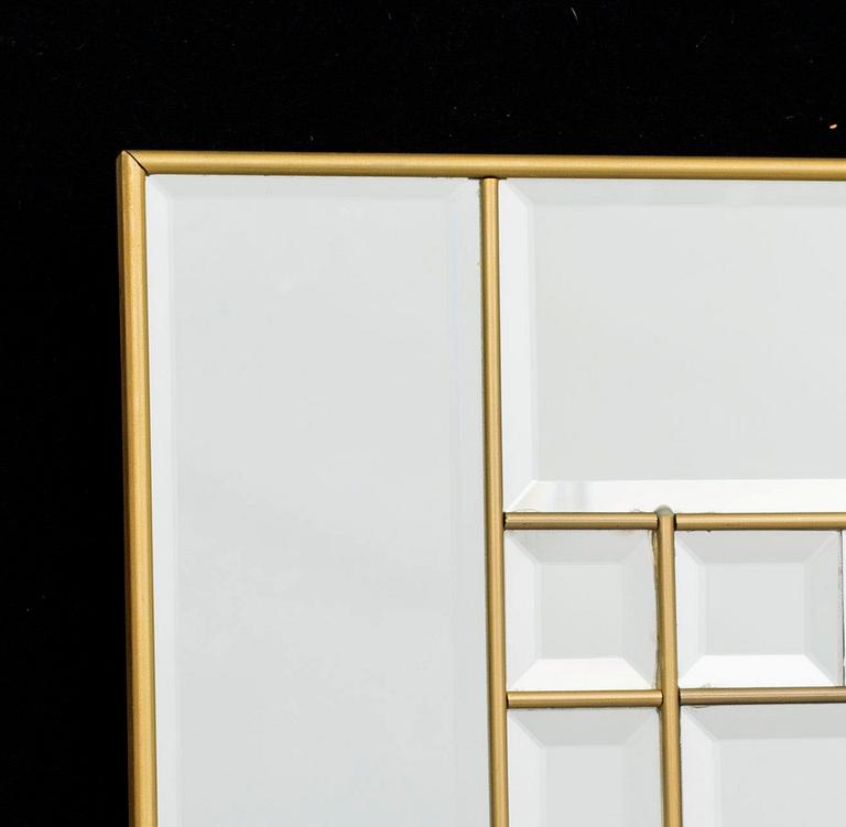 A BRASS WALL MIRROR.