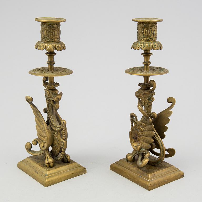 A pair of brass candle sticks late 19th century.