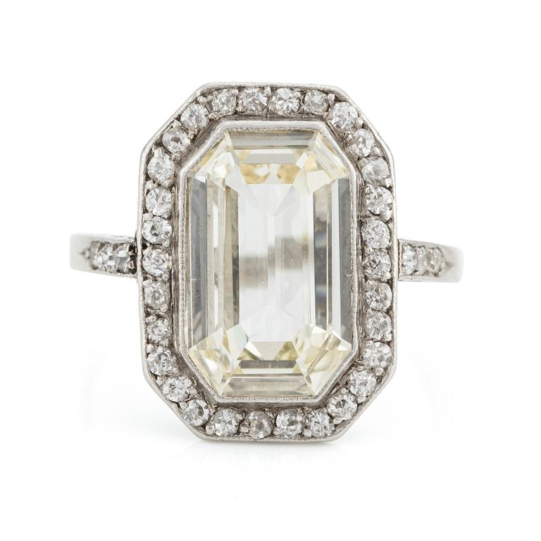 A platinum ring set with an emerald-cut diamond.