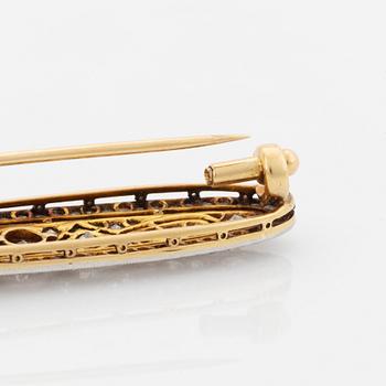 A platinum and 18K gold brooch set with old- and rose-cut diamonds.