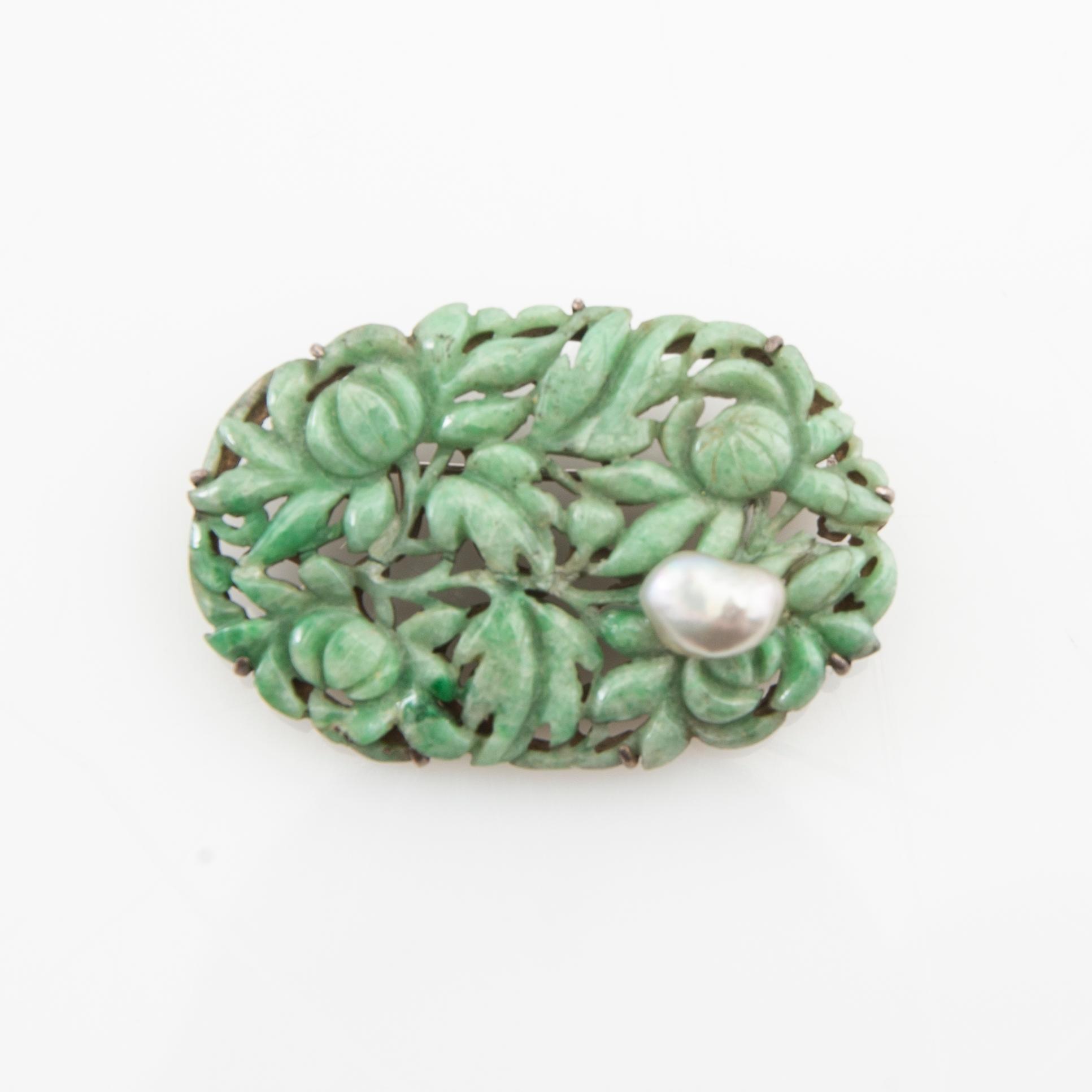 Brooch carved green stone with a cultured pearl set in silver, Japan.