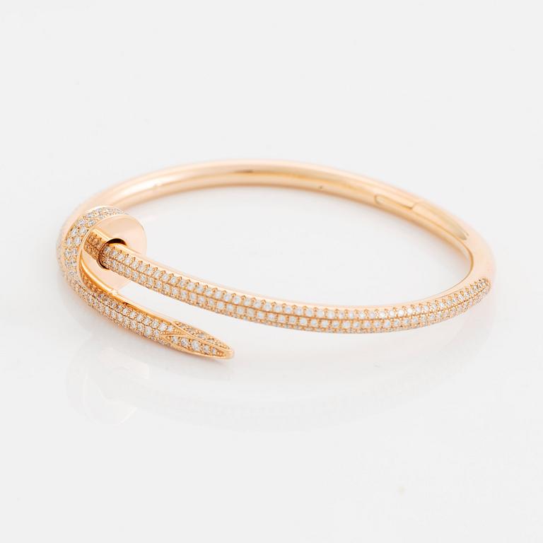 A Cartier "Juste en Clou" bracelet in 18K rose gold set with round brilliant-cut diamonds.