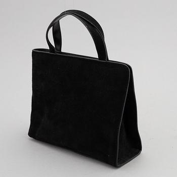 Gucci, a black suede handbag.