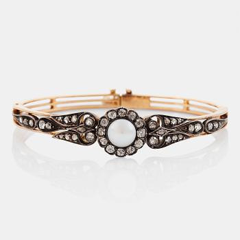 1008. An 18K gold and silver bracelet set with a bouton pearl and old- and rose-cut diamonds.