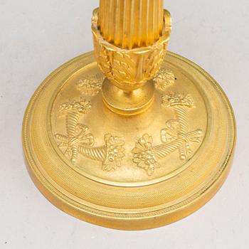 A pair of first half of the 19th century Empire candel sticks, gilded bronze, first half of the 19th century.