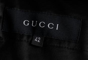 A two-piece black silk costume consisting of jacket and skirt by Gucci.