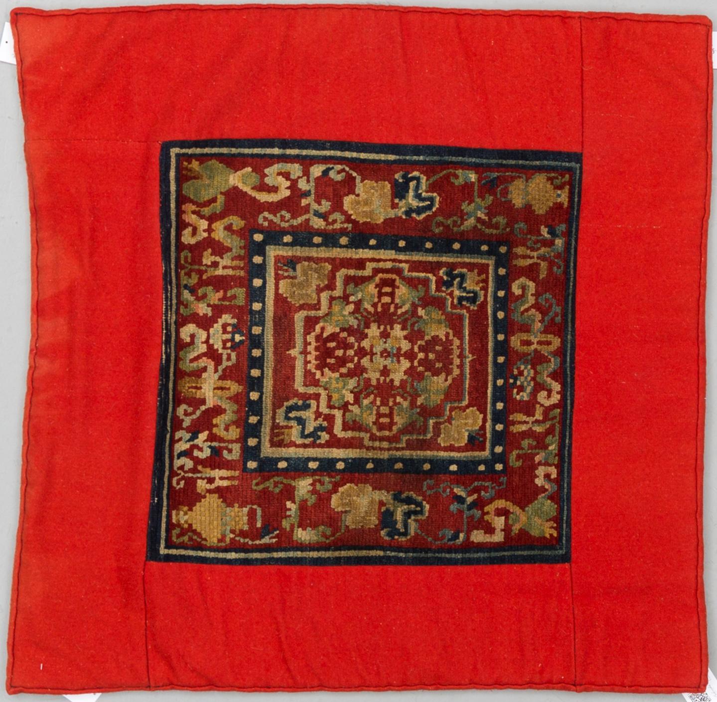 A MEDITATION RUG, one square, an antique Tibetan, ca 90,5 x 90,5 cm (including the fabric edgings).