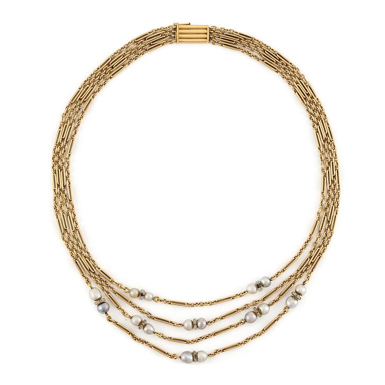 A W.A. Bolin necklace in 18K gold with pearls and white discs.
