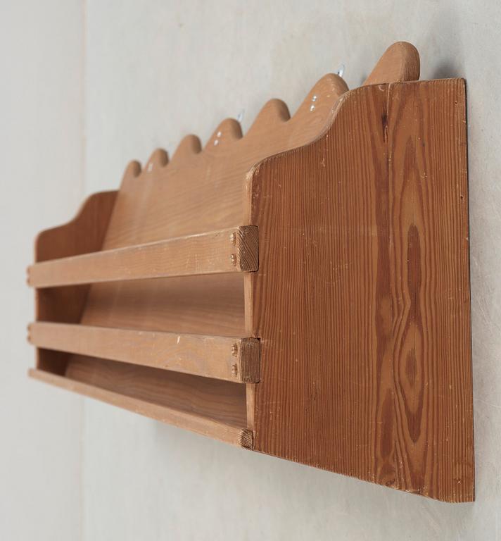 A stained pine wall-shelf attributted to Axel-Einar Hjorth, probably 'Utö', Nordiska Kompaniet, Sweden.