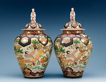 1588. A pair of Samson jars with covers.