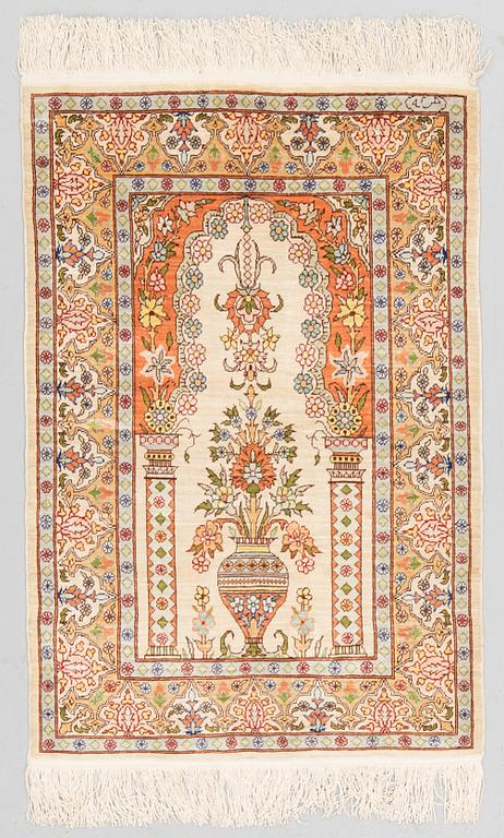 A RUG, Silk, Hereke, PROBABLY 82 x 54 cm.