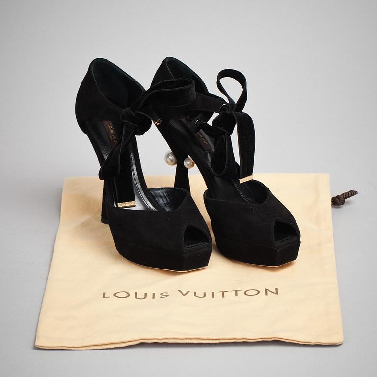 LOUIS VUITTON, a pair of black suede sandals.