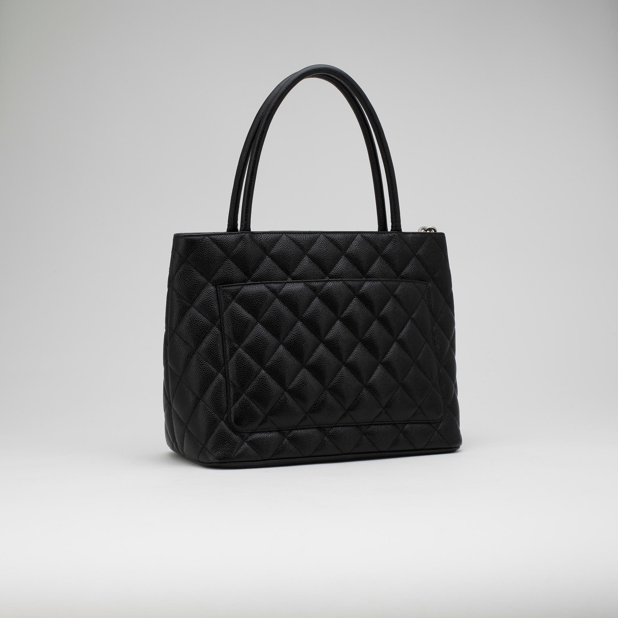 CHANEL, a black leather "Shopping" handbag.