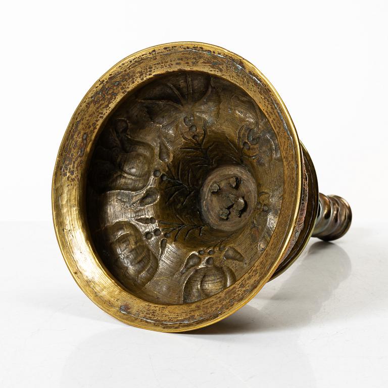 A Baroque brass candle stick, 18th century.