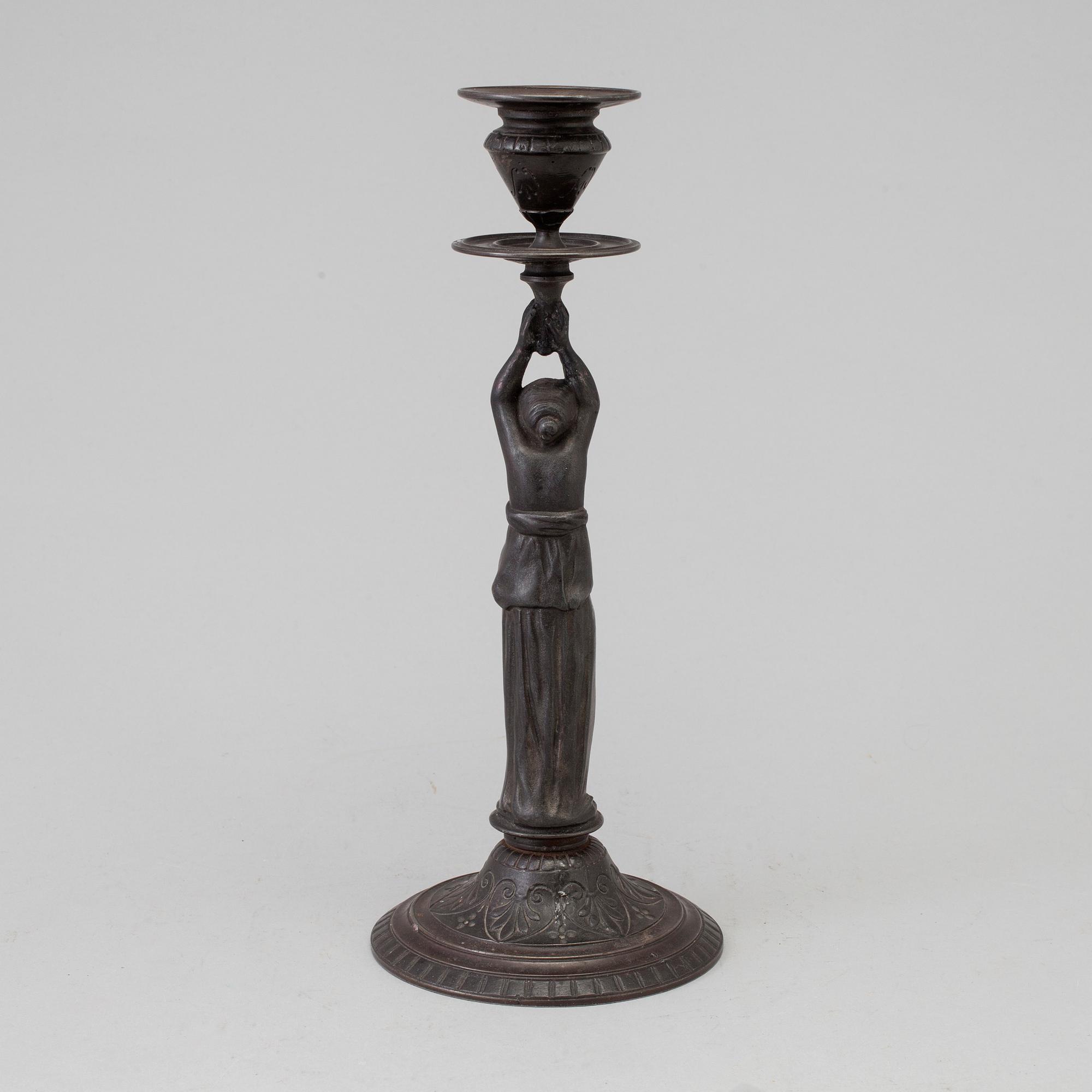 A 19th century iron candlestick marked F.L Vombach Offenbach A/M.