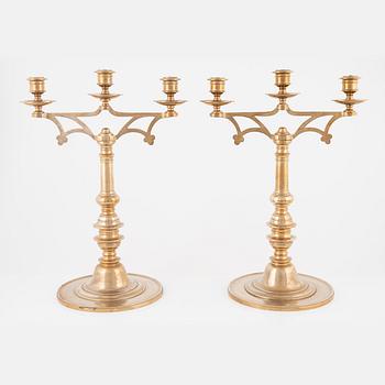 A pair of brass candelabra, early 20th Century.